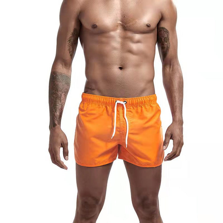 Durable quick-dry men's swim trunks with adjustable elastic waist, suitable for all summer water sports.
