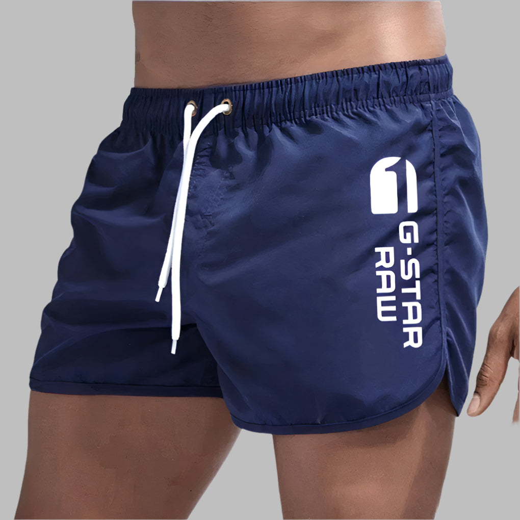 Quick-dry men's swim trunks for ultimate comfort. Essential beach shorts & pool swimwear for active summer days.