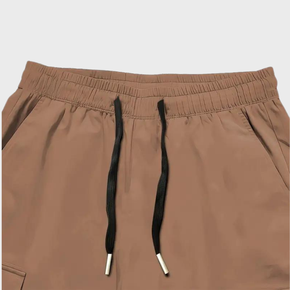 Relaxed fit men's utility cargo trousers with an adjustable drawstring waist, offering comfort and style.