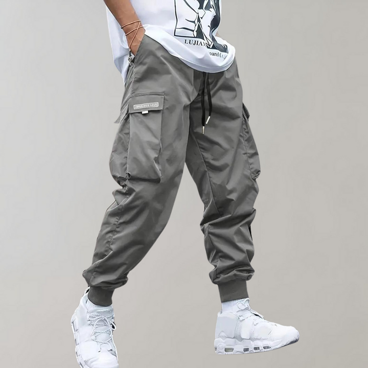 Stylish men's relaxed cargo trousers with drawstring, perfect as casual or utility pants for various outfits.