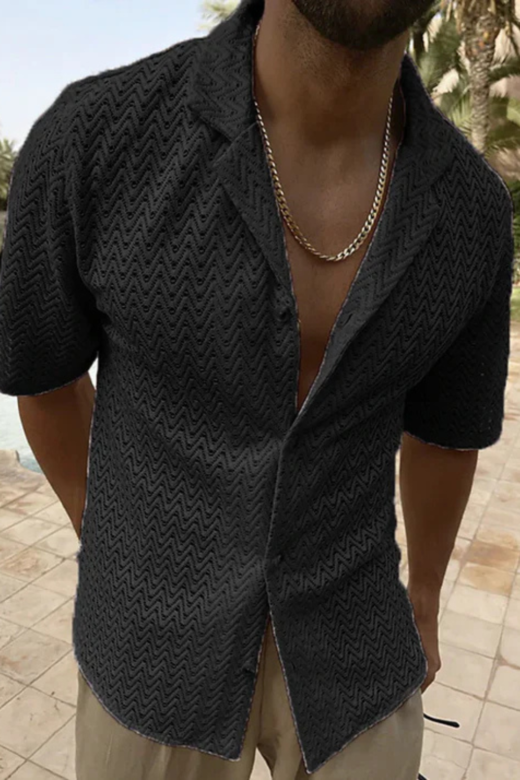 Relaxed fit men's button-up shirt with an open collar and a subtle chevron texture for casual summer wear.