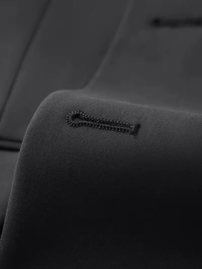 Close-up of the double-breasted jacket and waistcoat of a men's slim fit 3-piece suit.