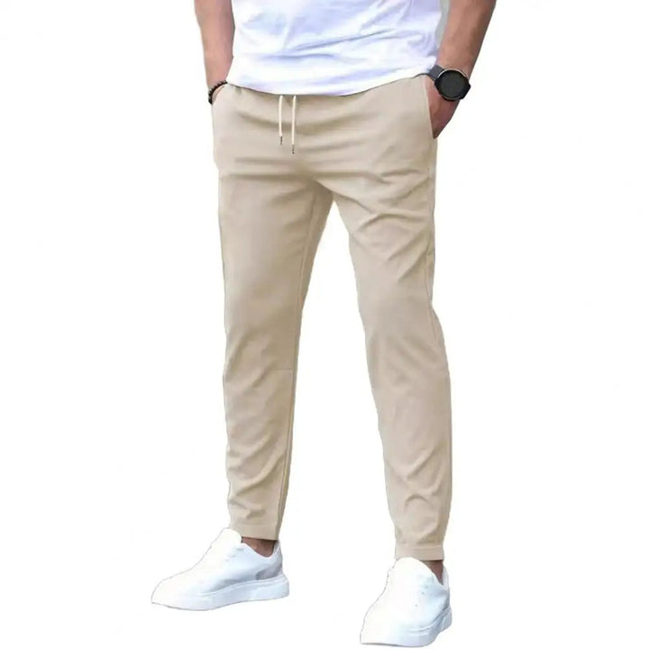 Man wearing sporty men's joggers, showcasing athletic fit, elastic waist, and pockets for activewear.