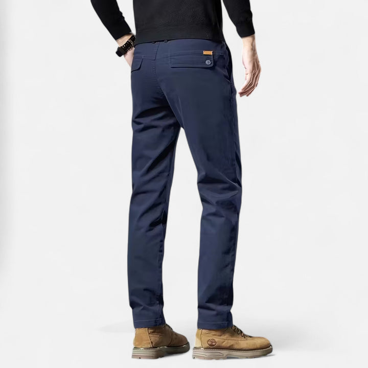 Detail shot: Men's straight-leg tailored trousers fabric & cut. Highlights classic style for versatile elegance.