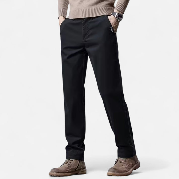 Man wearing straight-leg tailored trousers, styled for a smart casual look. Classic versatile men's fashion.