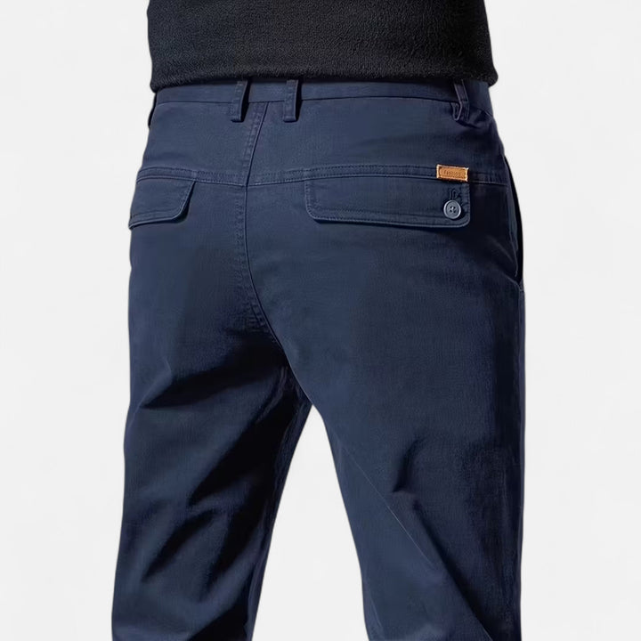 Man in black straight-leg tailored trousers, perfect for formal wear, business attire, and elegant menswear.