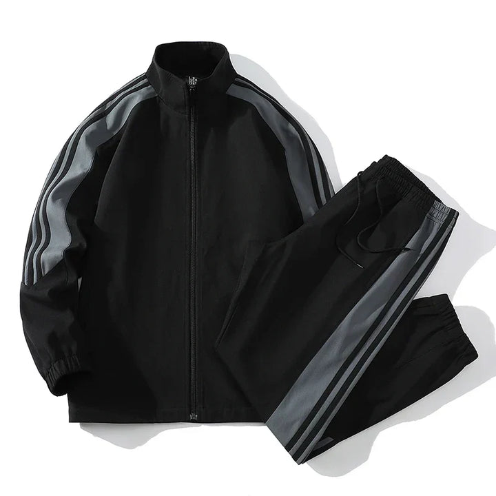 Men's fashionable two-piece tracksuit, full zip jacket, and joggers for streetwear or loungewear.