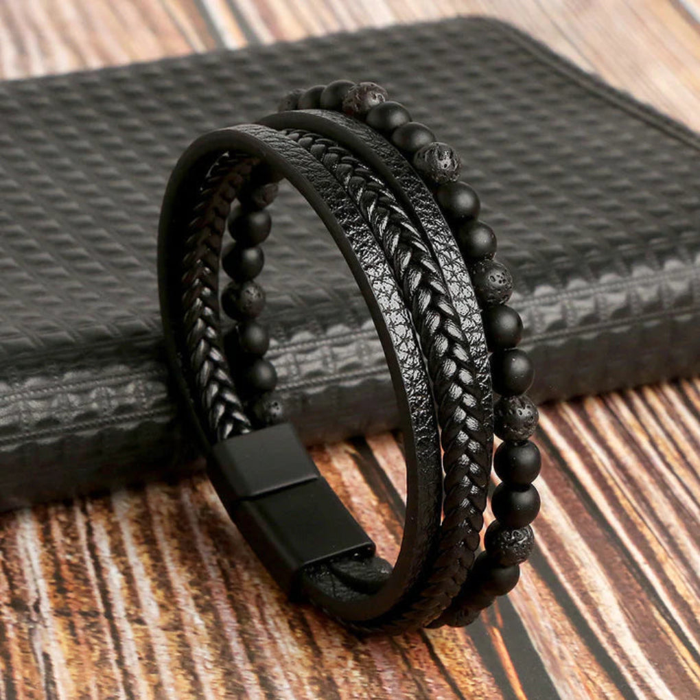 Close-up of men's edgy layered leather bracelet featuring natural stone beads and secure magnetic clasp.