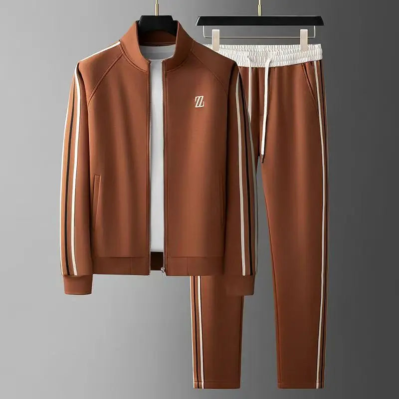 Man modeling urban two-piece tracksuit. Full zip jacket & joggers for comfortable activewear or casual style.