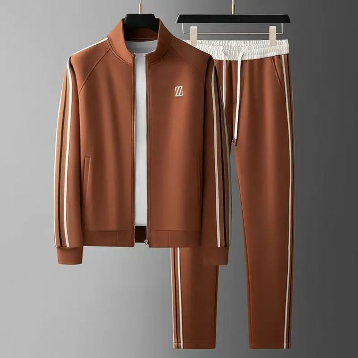 Man modeling urban two-piece tracksuit. Full zip jacket & joggers for comfortable activewear or casual style.