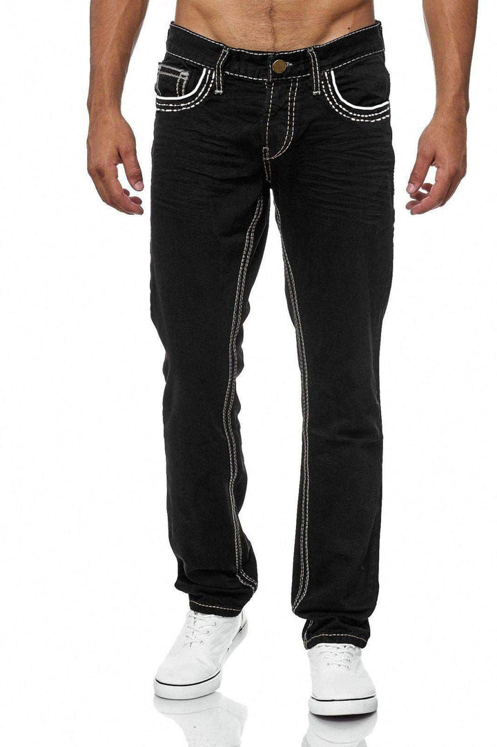 Man wearing used-style slim fit jeans with contrast stitching, ideal for a rugged yet fashionable casual outfit.