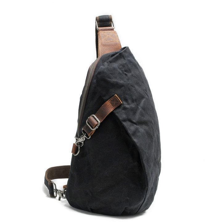 Water-resistant men's canvas sling bag, protecting daily essentials from rain and splashes.