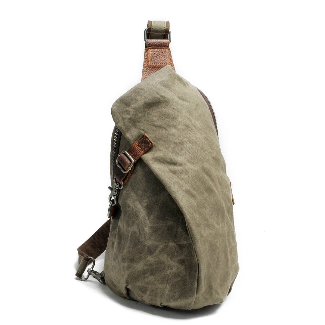 Durable water-resistant canvas men's sling bag, perfect for commuters. Front view.