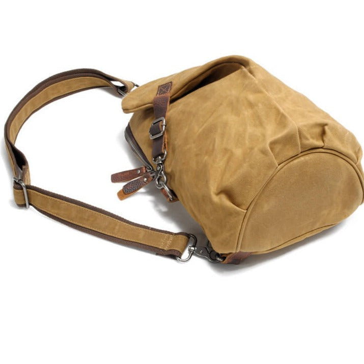 Close-up of the rugged water-resistant canvas fabric of the men's crossbody bag. Quality texture.