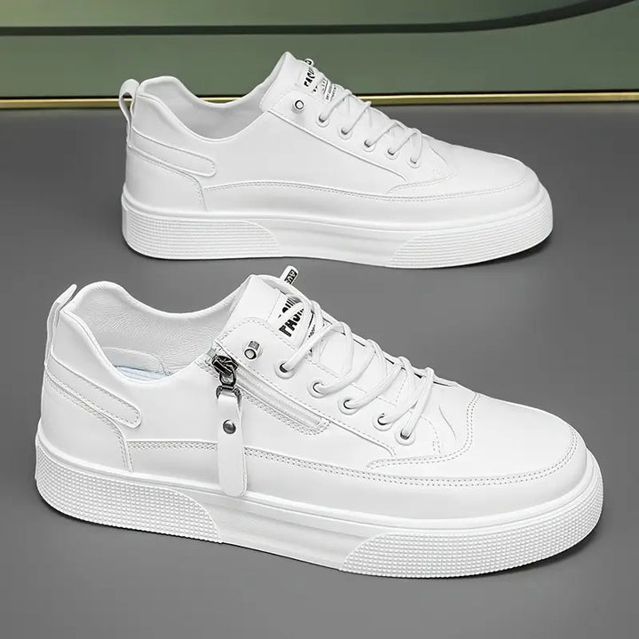 Close-up of a men's Hudson white leather trainer, showcasing the sleek design & functional side zip for quick wear.