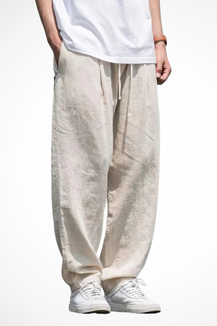 Men's wide leg trousers with elastic waist & front pockets in a relaxed fit. Ideal for casual fashion.