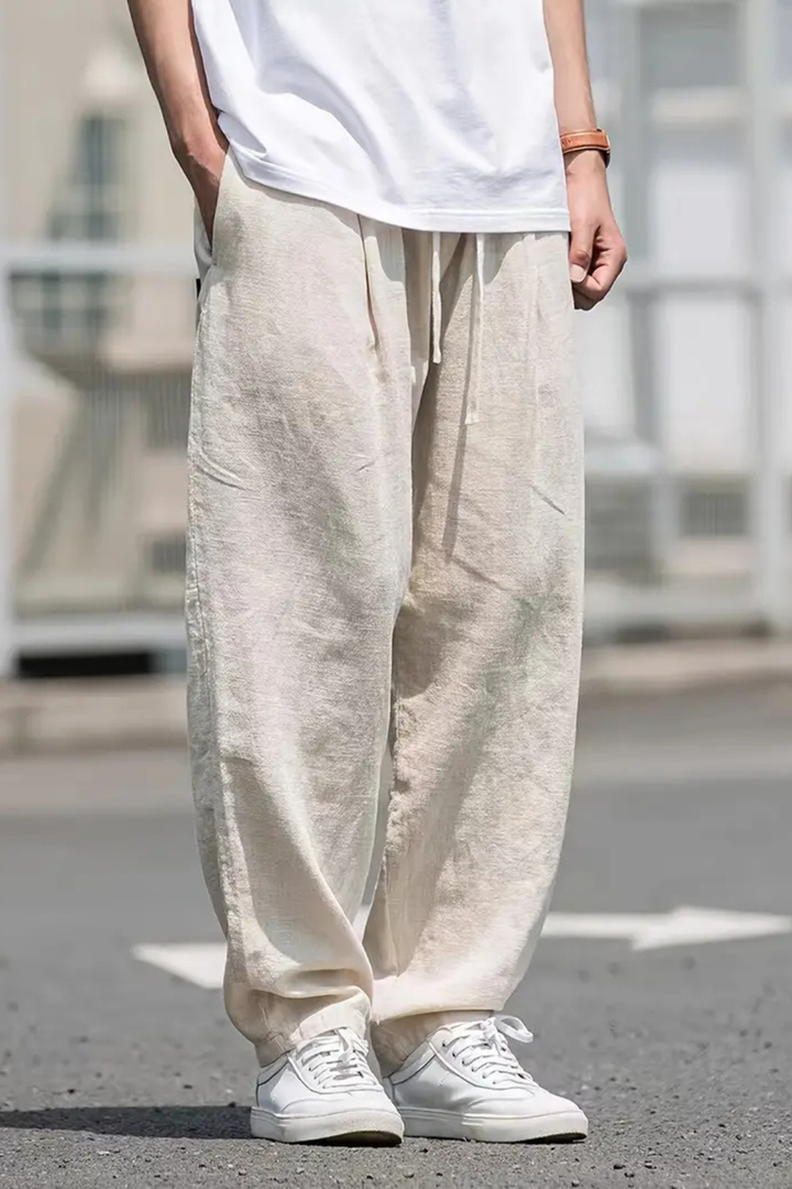 Khaki men's wide leg trousers, elastic waist & drawstring, relaxed fit, convenient front pockets.