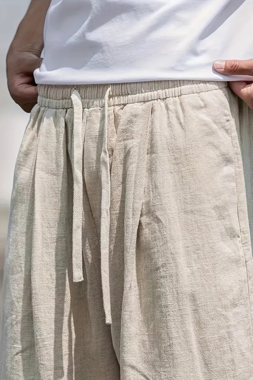 Relaxed fit men's wide leg trousers with elastic waist & practical front pockets. Comfortable casual wear.
