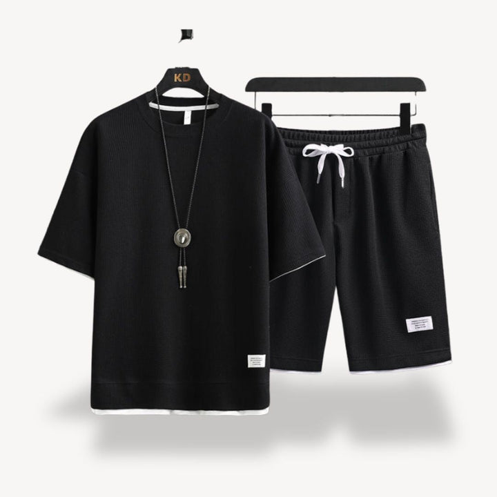 "Men wearing dark gray cotton jersey shorts set, showcasing relaxed fit and minimalist design for casual comfort"