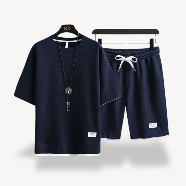 "Men wearing dark gray cotton jersey shorts set, showcasing relaxed fit and minimalist design for casual comfort"