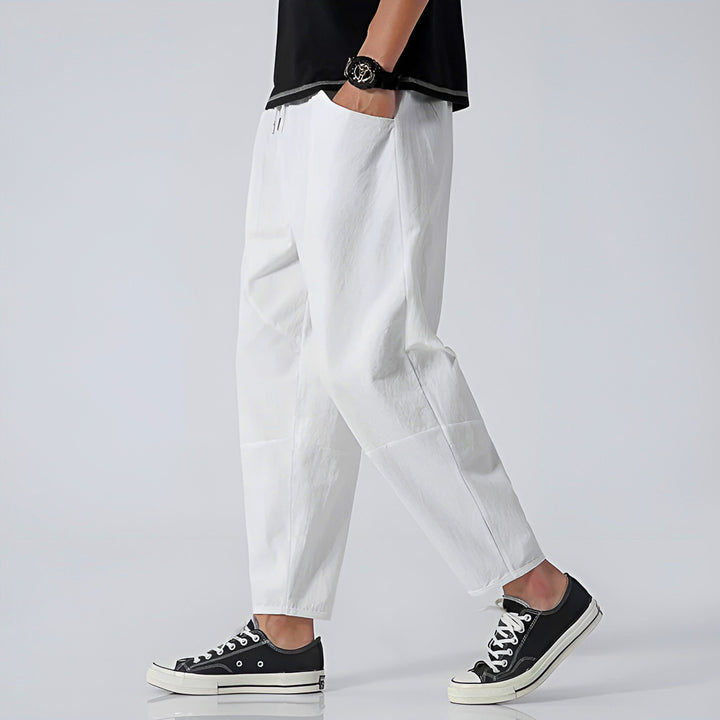 Men wearing relaxed fit cropped chinos in a casual summer setting, demonstrating everyday modern style.