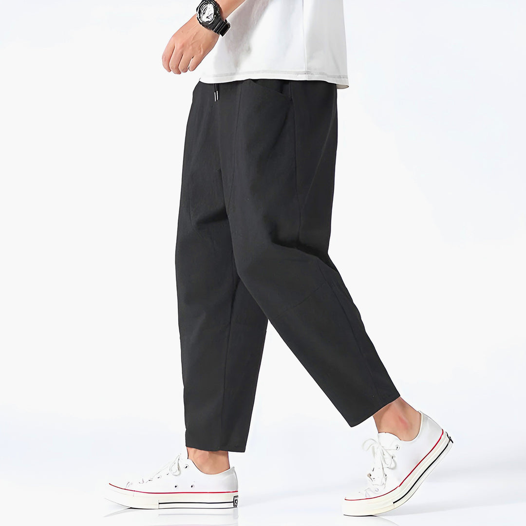 Neatly folded men's relaxed fit cropped chinos, ready for comfortable everyday casual and summer adventures.