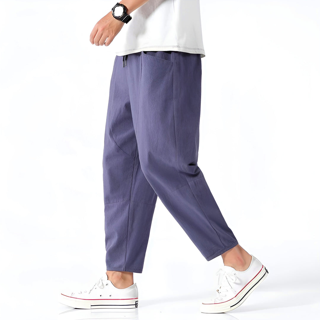 Close-up of men's relaxed fit cropped chinos, highlighting drawstring waistband for adjustable comfort.