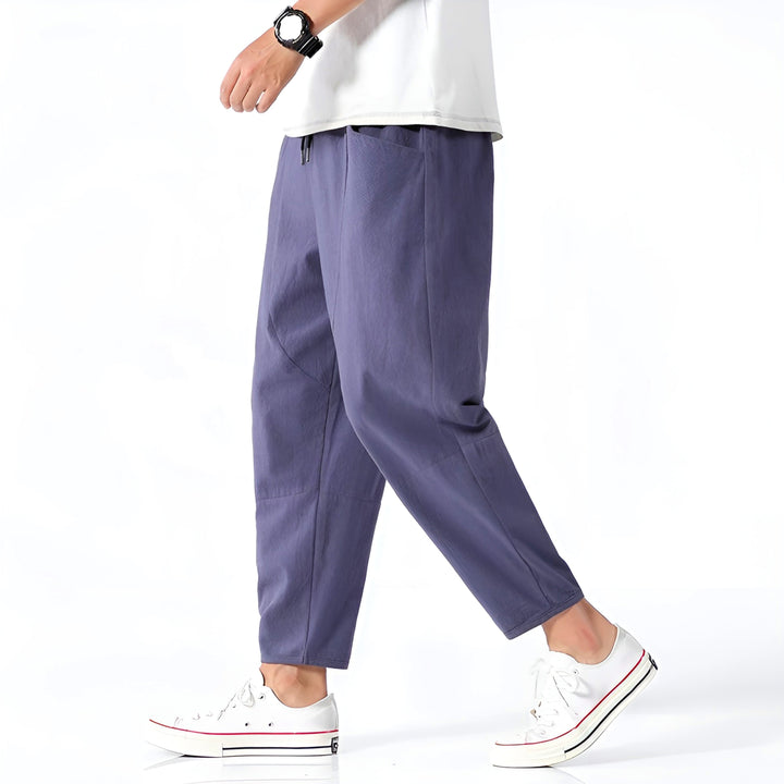 Close-up of men's relaxed fit cropped chinos, highlighting drawstring waistband for adjustable comfort.