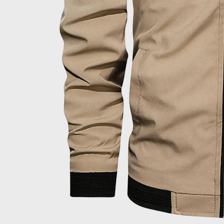 "Men's blue bomber jacket with zipper pockets, stylish fit, lightweight fabric, perfect for cool evenings."