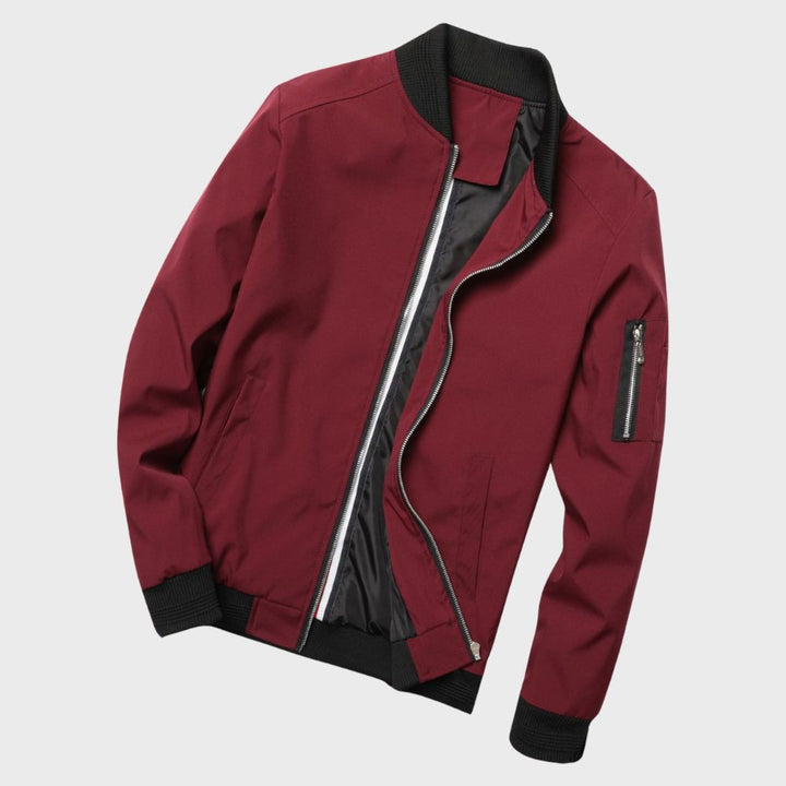 "Men's blue bomber jacket with zipper pockets, stylish fit, lightweight fabric, perfect for cool evenings."
