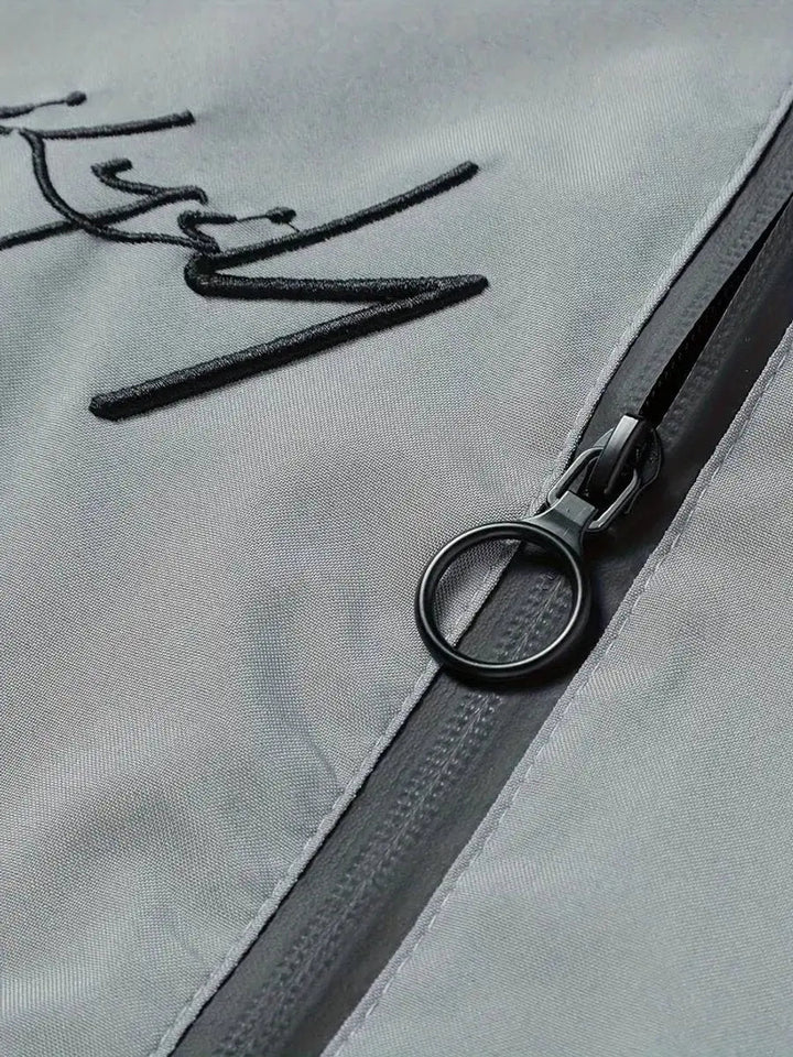 Close-up of lightweight fabric & ribbed trim on men's casual bomber jacket.