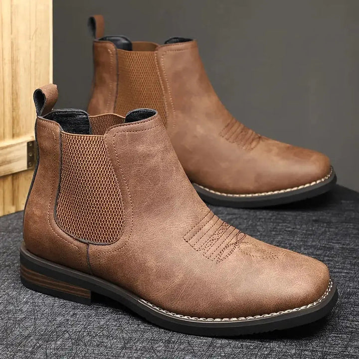Dark brown leather pull-on Chelsea boots for men, featuring a sleek profile.