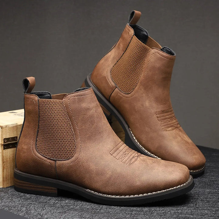 Elegant men's slip-on boots with subtle western stitch detail, perfect for contemporary style.