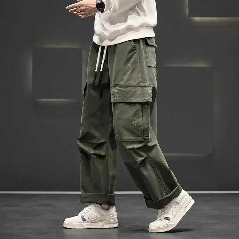 Men's straight leg green cargo trousers with multiple utility pockets for casual wear & outdoor activities.