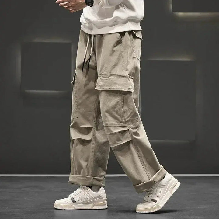 Black men's cargo pants featuring straight leg fit & multiple practical pockets, ideal for workwear or casual style.