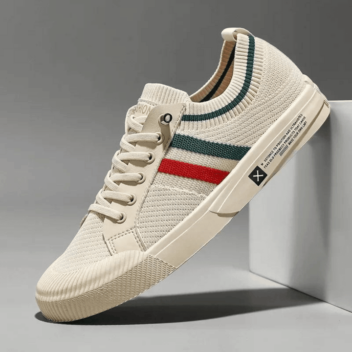 "Men’s casual sneakers in breathable knit fabric, lace-up design with durable rubber sole, perfect for everyday comfort."