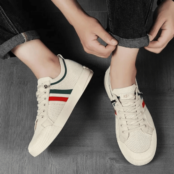 "Men’s casual sneakers in breathable knit fabric, lace-up design with durable rubber sole, perfect for everyday comfort."