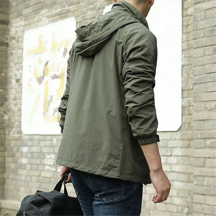 Men's lightweight breathable all-season jacket, sleek design, dark color, highlighting its comfort and versatility for layeri