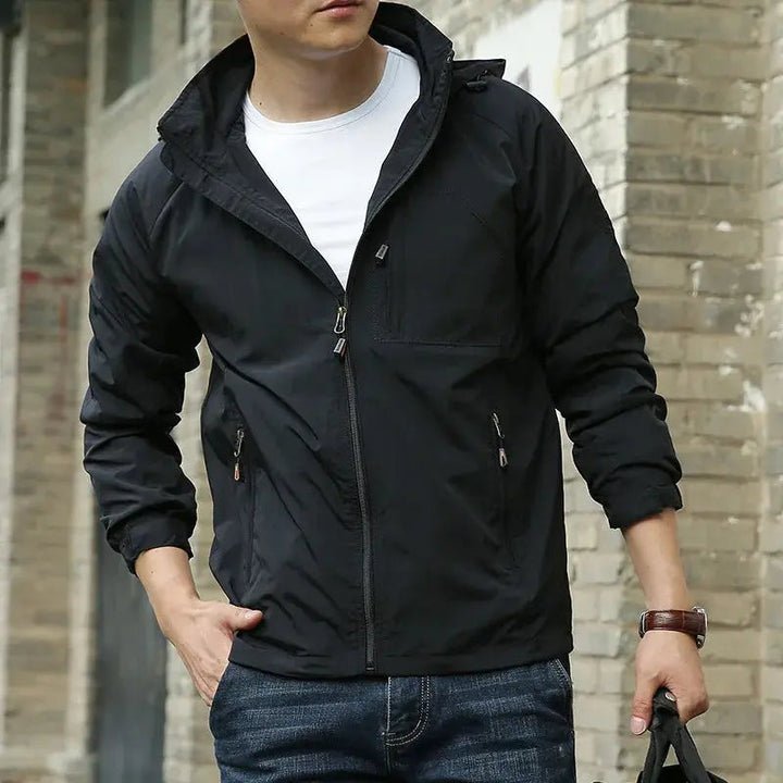 Men's lightweight breathable all-season jacket, sleek design, dark color, highlighting its comfort and versatility for layeri