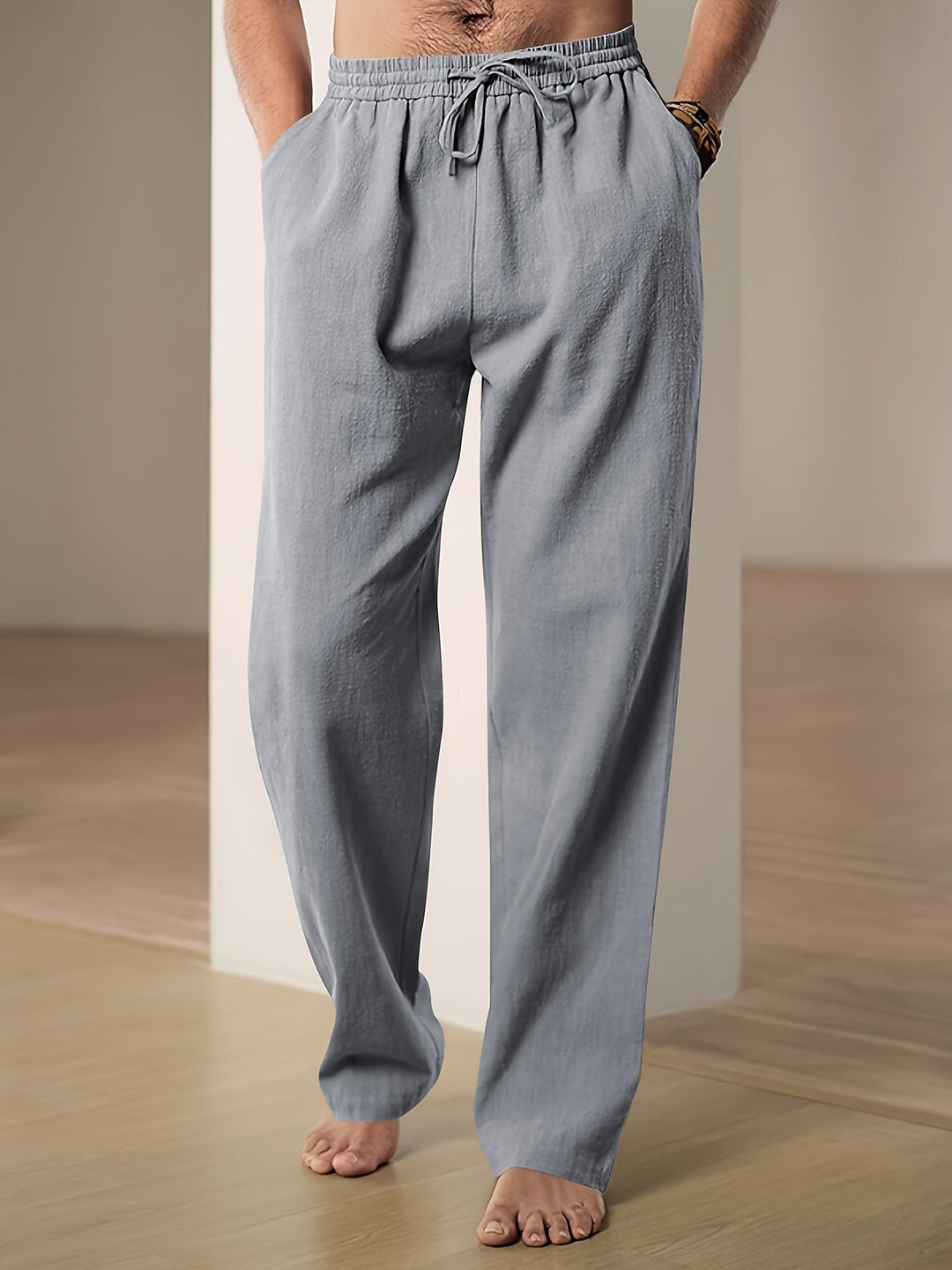 "Men's lightweight relaxed fit lounge trousers with drawstring waist, breathable fabric, shown in stylish grey tone."