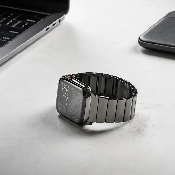 Men's sleek titanium watch band with shiny finish, magnetic clasp, durable and lightweight; perfect for daily or formal wear.