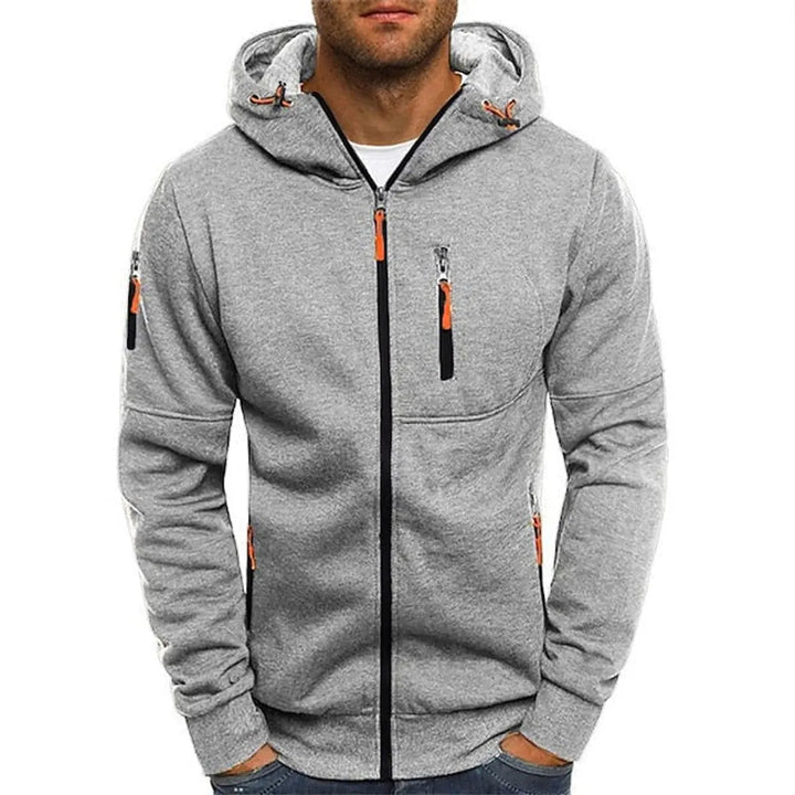 Detail of men's zip-up hoodie, highlighting soft fleece texture, durable zipper, and convenient multi-pockets.
