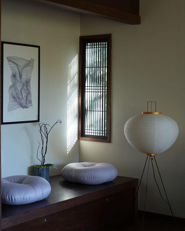 "Minimalist rice paper floor lamp with sleek metal frame and soft diffused light, perfect for creating a warm ambiance."