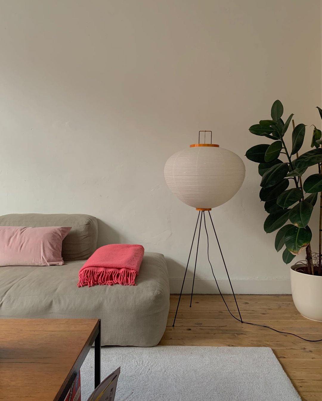 "Minimalist rice paper floor lamp with sleek metal frame and soft diffused light, perfect for creating a warm ambiance."
