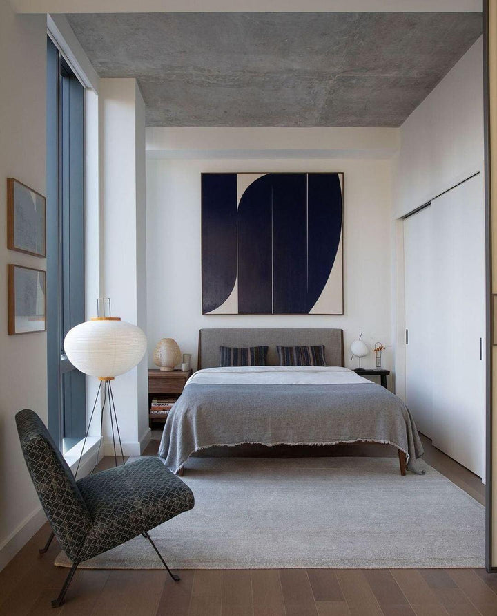 "Minimalist rice paper floor lamp with sleek metal frame and soft diffused light, perfect for creating a warm ambiance."