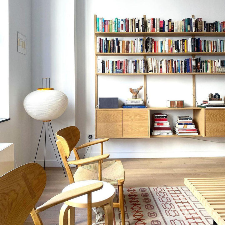 "Minimalist rice paper floor lamp with sleek metal frame and soft diffused light, perfect for creating a warm ambiance."