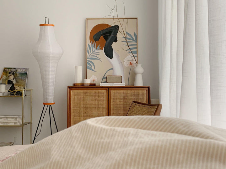 "Minimalist rice paper floor lamp with sleek metal frame and soft diffused light, perfect for creating a warm ambiance."