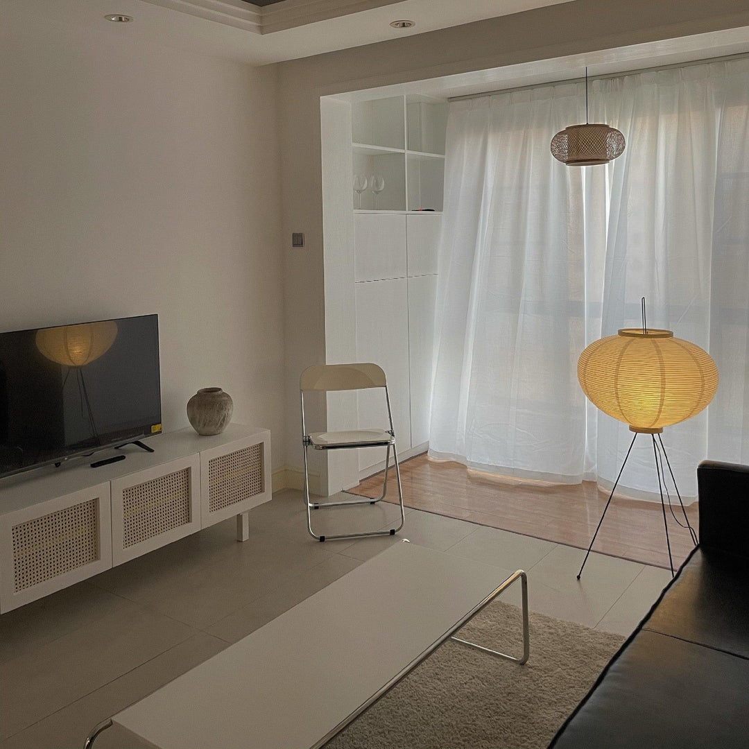 "Minimalist rice paper floor lamp with sleek metal frame and soft diffused light, perfect for creating a warm ambiance."