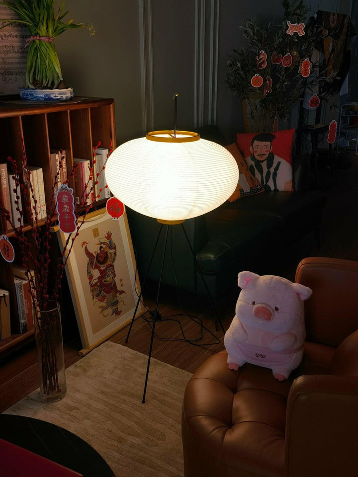"Minimalist rice paper floor lamp with sleek metal frame and soft diffused light, perfect for creating a warm ambiance."