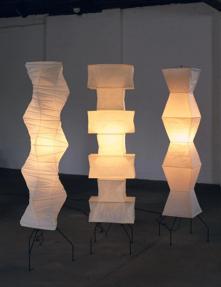 "Minimalist rice paper floor lamp with sleek metal frame and soft diffused light, perfect for creating a warm ambiance."